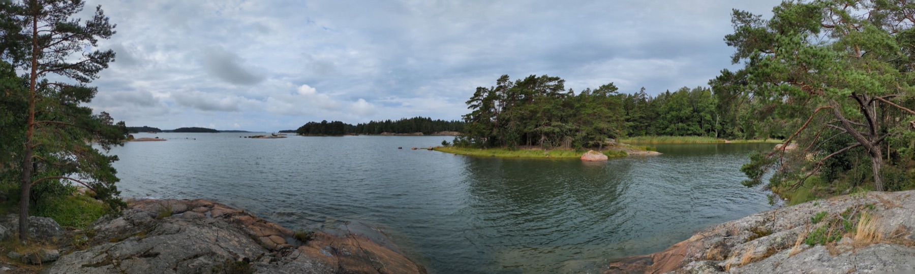 A panorama of the Finnish coast with rocky shores and wooded islands