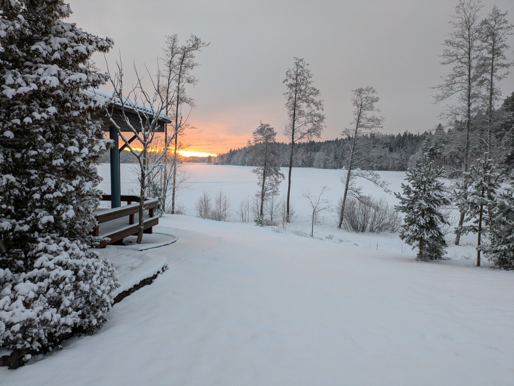 A golden winter sunset over a snow-covered frozen lake